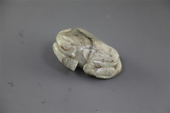 A Chinese pale celadon jade figure of a recumbent buffalo, Ming dynasty, length 11cm